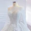 Luxe Blanche Transparentes La Mariée Robe De Mariée 2020 Robe Boule Encolure Dégagée Manches Longues Dos Nu Appliques Fleur Fait main Perlage Train De Balayage Volants