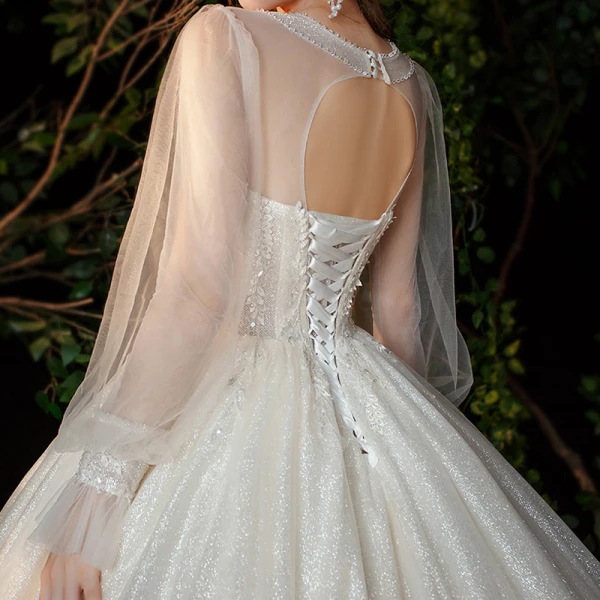 Victorian Style Champagne See-through Bridal Wedding Dresses 2020 Ball Gown Scoop Neck Puffy Long Sleeve Backless Appliques Lace Sequins Beading Glitter Tulle Cathedral Train Ruffle