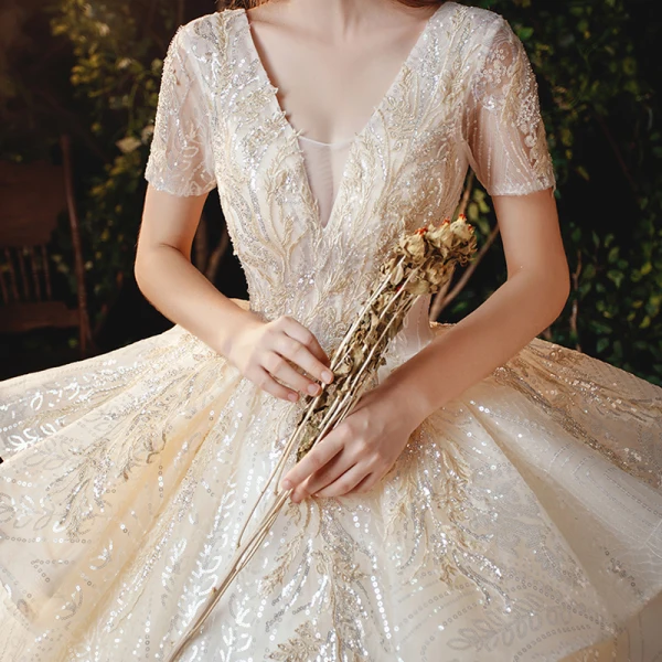 Sparkly Champagne Bridal Wedding Dresses 2020 Ball Gown V-Neck Short Sleeve Backless Appliques Sequins Cathedral Train Ruffle