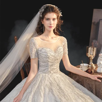 Eleganta Champagne Brud Bröllopsklänningar 2020 Balklänning Genomskinliga Urringning Korta Ärm Halterneck Paljetter Beading Glittriga Glitter Tyll Cathedral Train Ruffle