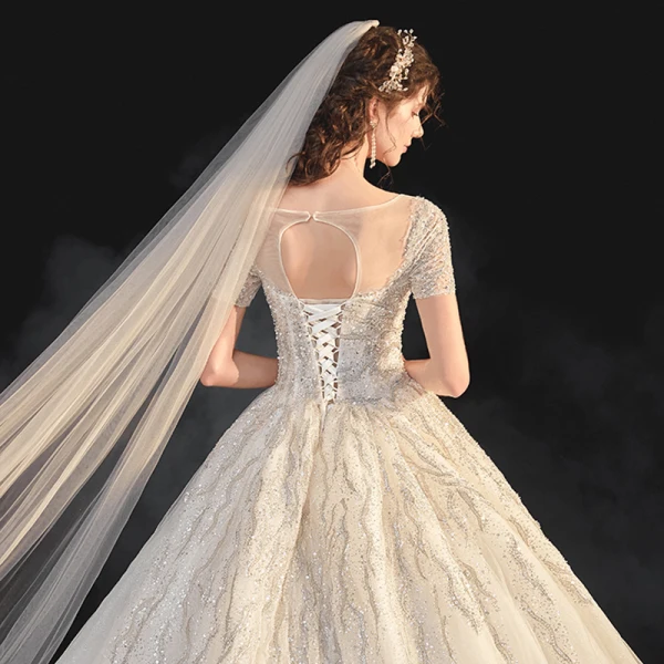 Élégant Champagne La Mariée Robe De Mariée 2020 Robe Boule Transparentes Encolure Dégagée Manches Courtes Dos Nu Paillettes Perlage Glitter Tulle Cathedral Train Volants