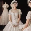 Luxury / Gorgeous Champagne Bridal Wedding Dresses 2021 Ball Gown See-through Scoop Neck Short Sleeve Backless Appliques Flower Beading Glitter Tulle Cathedral Train Ruffle