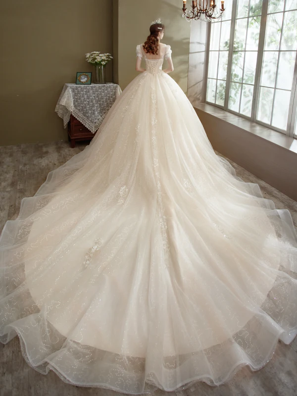 Romantique Champagne La Mariée Robe De Mariée 2021 Robe Boule Transparentes Encolure Dégagée Gonflée Manches Courtes Dos Nu Appliques En Dentelle Perlage Paillettes Glitter Tulle Cathedral Train Volants