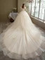 Romantique Champagne La Mariée Robe De Mariée 2021 Robe Boule Transparentes Encolure Dégagée Gonflée Manches Courtes Dos Nu Appliques En Dentelle Perlage Paillettes Glitter Tulle Cathedral Train Volants