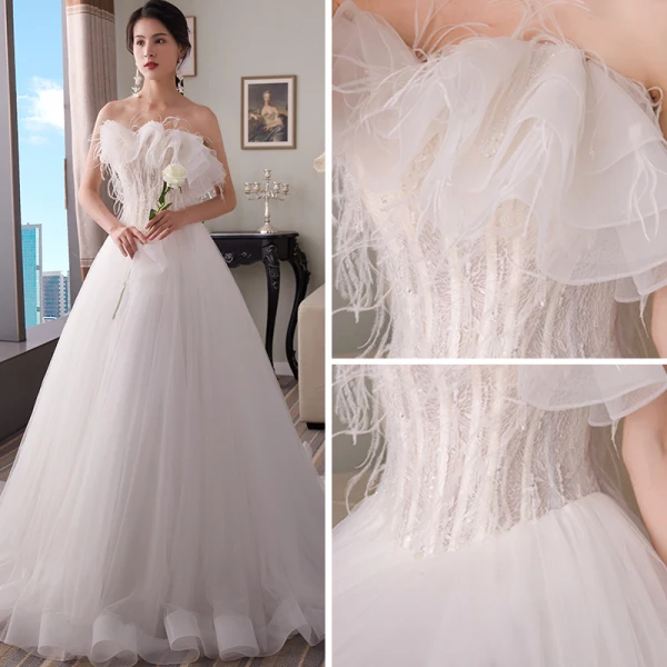 Élégant Blanche Robe De Mariée 2018 Princesse Bustier Sans Manches Dos Nu Plumes Perlage Train De Balayage Volants