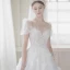 Illusion Champagne La Mariée Robe De Mariée 2021 Princesse Transparentes Encolure Dégagée Gonflée Manches Courtes Dos Nu Appliques En Dentelle Perlage Tribunal Train Volants