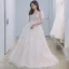 Illusion Champagne La Mariée Robe De Mariée 2021 Princesse Transparentes Encolure Dégagée Gonflée Manches Courtes Dos Nu Appliques En Dentelle Perlage Tribunal Train Volants