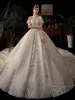 Luxury / Gorgeous Champagne See-through Bridal Wedding Dresses 2021 Ball Gown High Neck Short Sleeve Backless Handmade  Beading Sequins Glitter Tulle Royal Train Ruffle