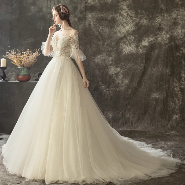 Illusion Champagne Transparentes Robe De Mariée 2019 Princesse Encolure Dégagée Manches de cloche Appliques En Dentelle Perle Glitter Tulle Tribunal Train Volants