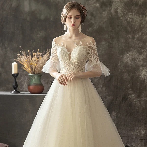 Illusion Champagne Transparentes Robe De Mariée 2019 Princesse Encolure Dégagée Manches de cloche Appliques En Dentelle Perle Glitter Tulle Tribunal Train Volants