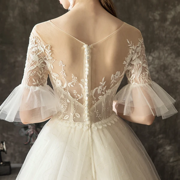 Illusion Champagne Transparentes Robe De Mariée 2019 Princesse Encolure Dégagée Manches de cloche Appliques En Dentelle Perle Glitter Tulle Tribunal Train Volants