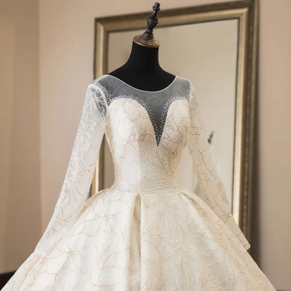 Luxury / Gorgeous Champagne See-through Wedding Dresses 2019 Ball Gown Scoop Neck Long Sleeve Backless Appliques Lace Beading Cathedral Train Ruffle