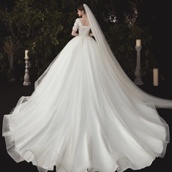 Elegant Ivory Wedding Dresses 2020 Ball Gown Deep V-Neck Pearl Lace Flower Appliques Short Sleeve Backless Cathedral Train