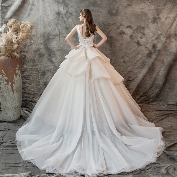 Charming Champagne Wedding Dresses 2019 Ball Gown V-Neck Pearl Sleeveless Backless Cascading Ruffles Cathedral Train