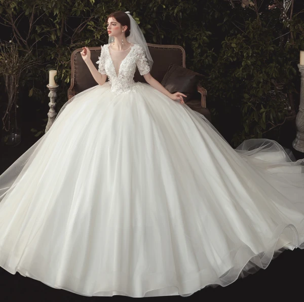 Elegant Ivory Wedding Dresses 2020 Ball Gown Deep V-Neck Pearl Lace Flower Appliques Short Sleeve Backless Cathedral Train