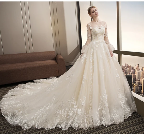Stunning Champagne Wedding Dresses 2018 Ball Gown Lace Appliques Pearl Scoop Neck Backless Long Sleeve Royal Train Wedding