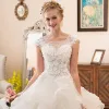Illusion Ivory See-through Wedding Dresses 2018 Ball Gown Scoop Neck Sleeveless Appliques Flower Beading Pearl Cathedral Train Ruffle