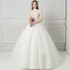 Chic / Beautiful Ivory See-through Wedding Dresses 2018 Ball Gown High Neck Sleeveless Backless Beading Pearl Rhinestone Ruffle Court Train