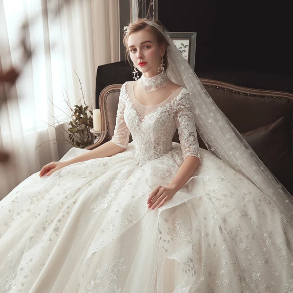 Romantique Ivoire Transparentes Robe De Mariée 2020 Robe Boule Encolure Dégagée 1/2 Manches Dos Nu Glitter Tulle Étoile Appliques En Dentelle Chapel Train Volants