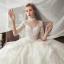 Romantique Ivoire Transparentes Robe De Mariée 2020 Robe Boule Encolure Dégagée 1/2 Manches Dos Nu Glitter Tulle Étoile Appliques En Dentelle Chapel Train Volants