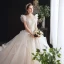 Chic / Belle Transparentes Champagne Robe De Mariée 2020 Robe Boule Col Haut Sans Manches Dos Nu Appliques En Dentelle Perlage Cathedral Train Volants