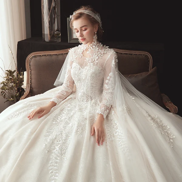 Conte de fée Champagne Transparentes Robe De Mariée Avec Cape 2020 Robe Boule Col Haut 3/4 Manches Dos Nu Appliques En Dentelle Perlage Watteau Train Volants