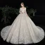 Charmant Champagne Transparentes Robe De Mariée 2020 Robe Boule Encolure Dégagée Manches Longues Dos Nu Glitter Tulle Appliques En Dentelle Perlage Royal Train Volants