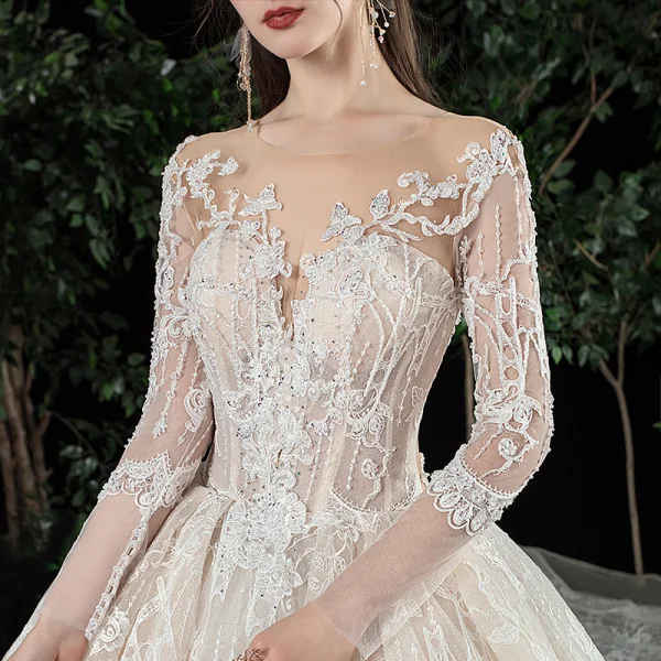 Charmant Champagne Transparentes Robe De Mariée 2020 Robe Boule Encolure Dégagée Manches Longues Dos Nu Glitter Tulle Appliques En Dentelle Perlage Royal Train Volants