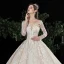 Charmant Champagne Transparentes Robe De Mariée 2020 Robe Boule Encolure Dégagée Manches Longues Dos Nu Glitter Tulle Appliques En Dentelle Perlage Royal Train Volants