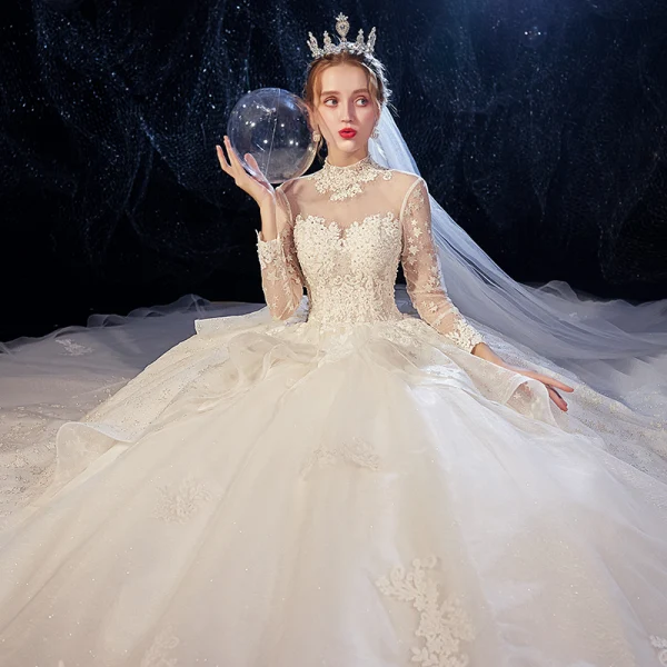 Vintage / Originale Ivoire Transparentes Robe De Mariée 2020 Robe Boule Col Haut Manches Longues Dos Nu Glitter Tulle Appliques En Dentelle Perlage Chapel Train Volants