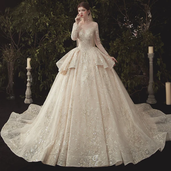 Charming Champagne See-through Wedding Dresses 2020 Ball Gown Scoop Neck Long Sleeve Backless Glitter Appliques Lace Court Train Ruffle