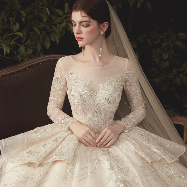Charming Champagne See-through Wedding Dresses 2020 Ball Gown Scoop Neck Long Sleeve Backless Glitter Appliques Lace Court Train Ruffle