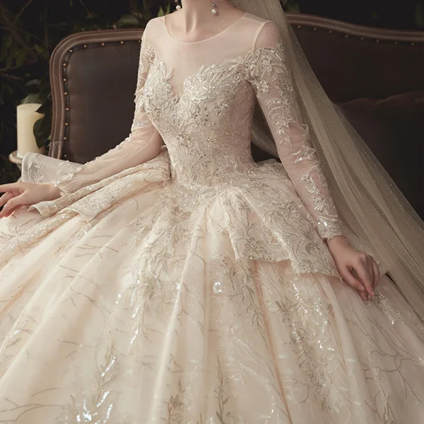 Charming Champagne See-through Wedding Dresses 2020 Ball Gown Scoop Neck Long Sleeve Backless Glitter Appliques Lace Court Train Ruffle