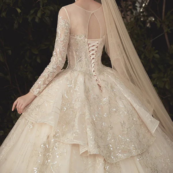 Charming Champagne See-through Wedding Dresses 2020 Ball Gown Scoop Neck Long Sleeve Backless Glitter Appliques Lace Court Train Ruffle