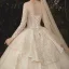 Charming Champagne See-through Wedding Dresses 2020 Ball Gown Scoop Neck Long Sleeve Backless Glitter Appliques Lace Court Train Ruffle