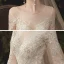 Charming Champagne See-through Wedding Dresses 2020 Ball Gown Scoop Neck Long Sleeve Backless Glitter Appliques Lace Court Train Ruffle