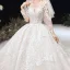 Luxe Champagne Transparentes Robe De Mariée 2020 Robe Boule Encolure Dégagée 3/4 Manches Fait main Perlage Glitter Tulle Appliques En Dentelle Royal Train Volants