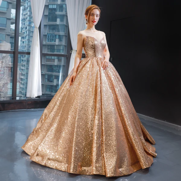 Scintillantes Champagne Paillettes Dansant Robe De Bal 2023 Robe Boule Transparentes Encolure Dégagée Sans Manches Longue Volants Dos Nu Robe De Ceremonie