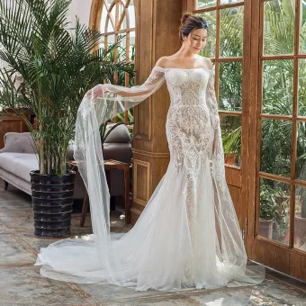 Élégant Ivoire Plage Robe De Mariée 2023 Trompette Sirène De L Épaule Manches Longues Dos Nu Appliques En Dentelle Tribunal Train Volants
