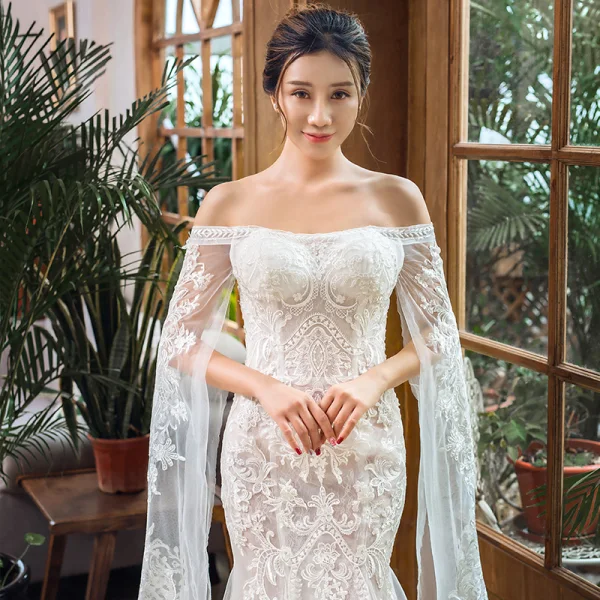 Elegant Ivory Beach Wedding Dresses 2023 Trumpet / Mermaid Off-The-Shoulder Long Sleeve Backless Appliques Lace Court Train Ruffle