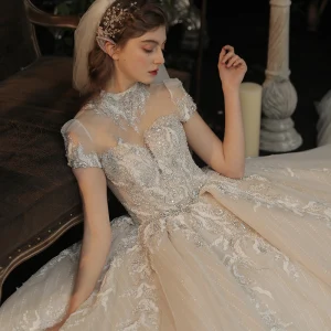 Luxe Champagne Transparentes La Mariée Robe De Mariée 2020 Robe Boule Col Haut Manches Courtes Dos Nu Appliques En Dentelle Fait Main Perlage Glitter Tulle Cathedral Train