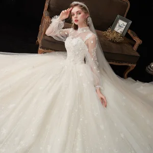 Victoriaanse Stijl Champagne Doorzichtige Bruids Trouwjurken 2020 Baljurk Hoge Kraag Gezwollen Lange Mouwen Ruglooze Glans Tule Appliques Kant Kralen Cathedral Train Ruche