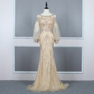 Haut De Gamme Doré Transparentes Robe De Soirée 2020 Trompette Sirène Encolure Dégagée Gonflée Manches Longues Perlage Train De Balayage Volants Robe De Ceremonie