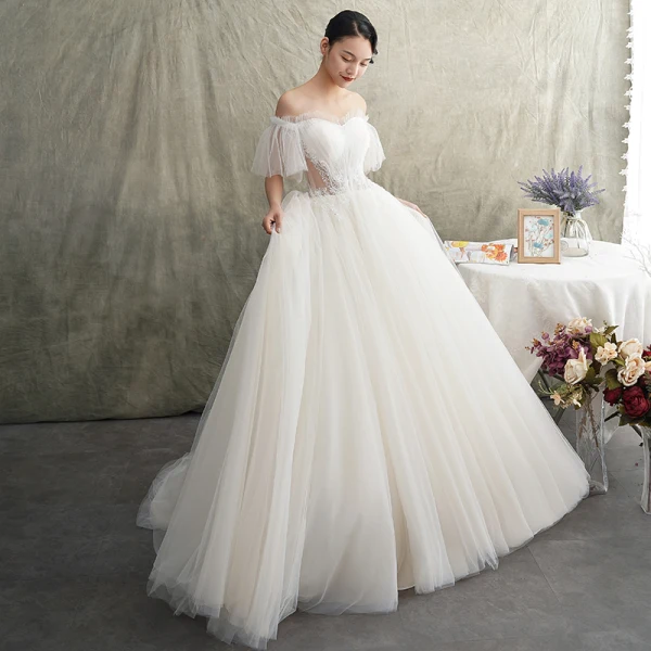 Elegante Ivory / Creme Durchsichtige Brautkleider / Hochzeitskleider 2019 Prinzessin Off Shoulder Kurze Ärmel Rückenfreies Perlenstickerei Sweep / Pinsel Zug Rüschen