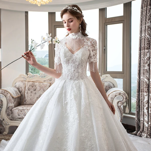 Luxe Ivoire Transparentes Robe De Mariée 2019 Robe Boule Col Haut Manches Courtes Dos Nu Perlage Gland Appliques En Dentelle Glitter Tulle Cathedral Train Volants