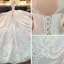 Elegante Ivory / Creme Durchsichtige Brautkleider / Hochzeitskleider 2019 A Linie Rundhalsausschnitt Lange Ärmel Rückenfreies Perlenstickerei Glanz Tülle Kapelle-Schleppe Rüschen