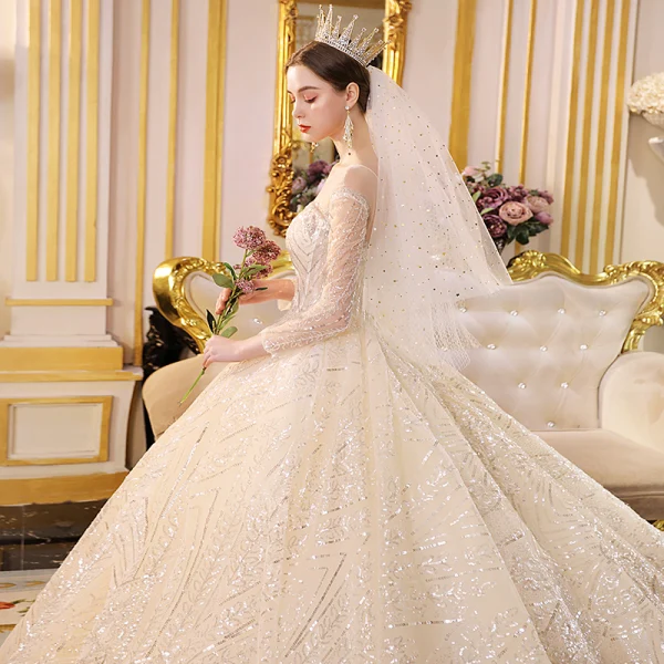 Sparkly Champagne See-through Wedding Dresses 2019 Ball Gown Scoop Neck Long Sleeve Backless Glitter Sequins Cathedral Train Ruffle