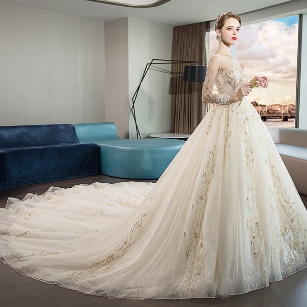 Élégant Champagne Transparentes Robe De Mariée 2019 Princesse Encolure Dégagée Manches Longues Dos Nu Cristal Perlage Appliques En Dentelle Cathedral Train Volants