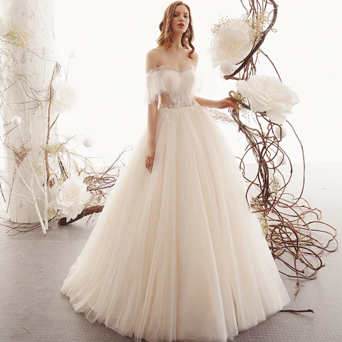 Beste Champagne Gjennomsiktig Hage Utendørs Brudekjoler 2019 Prinsesse Kjæreste Korte Ermer Ryggløse Beading Lange Buste