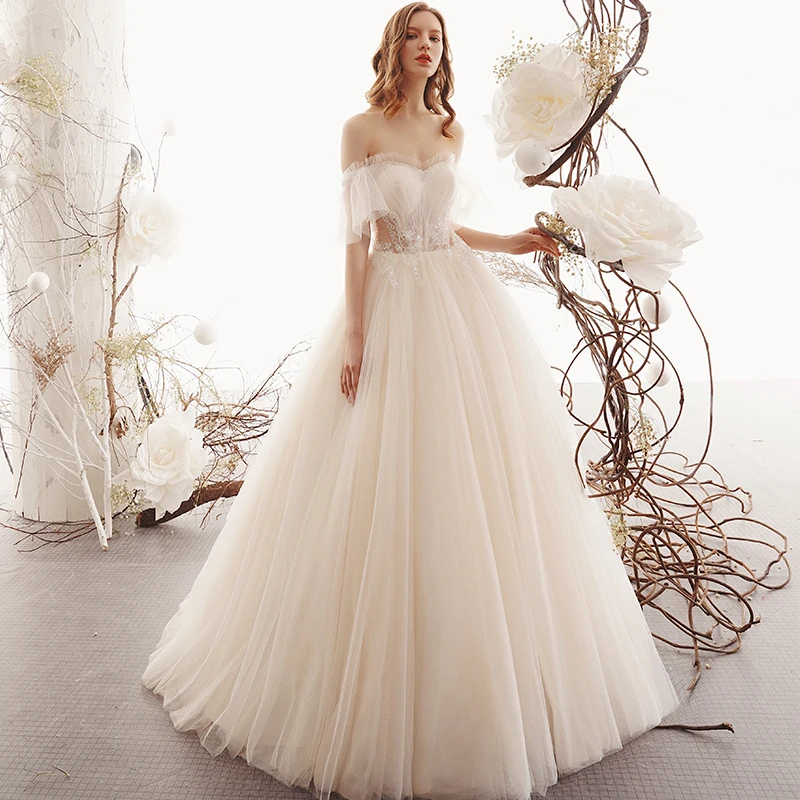 Beste Champagne Gjennomsiktig Hage Utendørs Brudekjoler 2019 Prinsesse Kjæreste Korte Ermer Ryggløse Beading Lange Buste